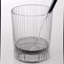 a plastic cup with a black spoon in it