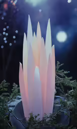 pink colored sculpture with green plant life outside