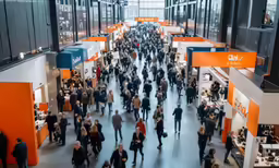 a group of people walking down a hall near a long counter