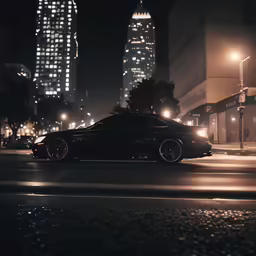 a black car with some buildings in the back