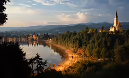 a lake at sunset with a church lit up