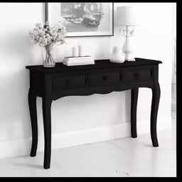 this black desk has three drawers underneath it