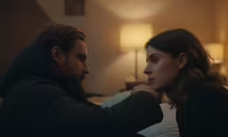 a woman and man are looking at each other