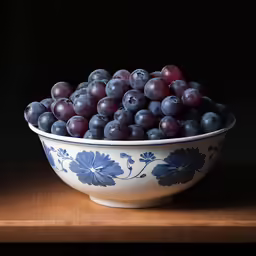 some grapes in a bowl on top of a table