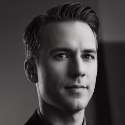 a black and white photo of a man in formal wear