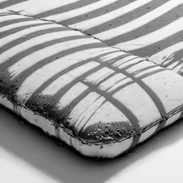an image of a dirty mattress with black and white striped fabric