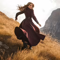 a woman in a purple dress is running on a hill