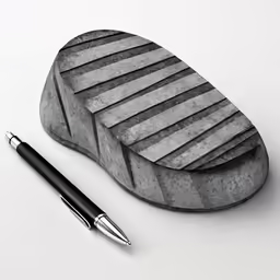 a pen resting on top of a wooden carving