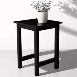 the small table is decorated with an adorable plant