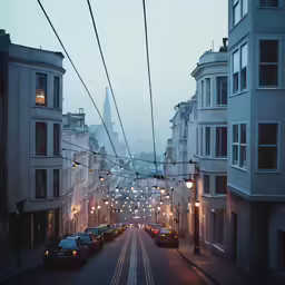 cars and wires on the road in a city