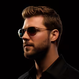 a young man with dark sunglasses, and his hair pulled back