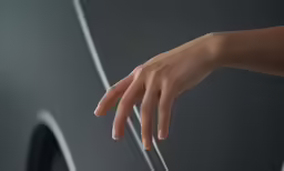 someone holding their hand out against a black background