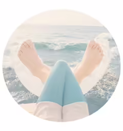 a round image of a person sitting on the beach