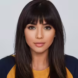 a woman with long bangs and light brown eyes