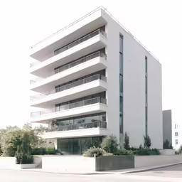 a modern building with several balconies near the street