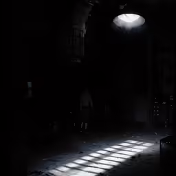 an open doorway and light on it that looks like a dark room