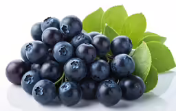 blueberries with leaves laying on a table