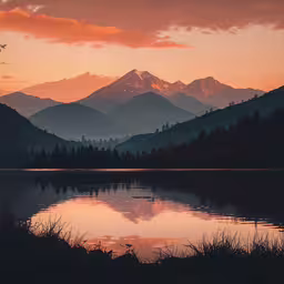 the sun is rising over the mountains and lake,the sun sets over a calm mountain lake with a reflection in it