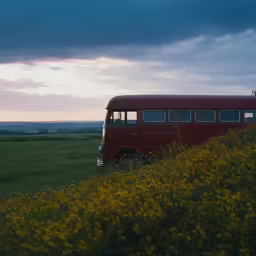 an old red bus is parked in a green field