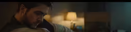 a man in a hotel room looking at something