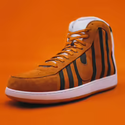 a pair of shoes is shown on an orange surface