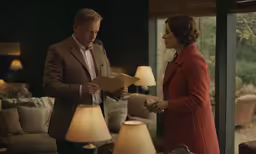 two men standing next to each other with a menu in hand