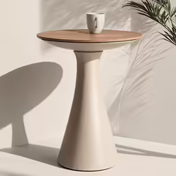 a table with a cup and small plant in it
