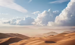 some white clouds in the sky over a desert