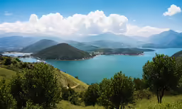 the mountains are visible next to a large body of water