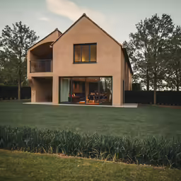 a house with lots of windows sits in the grass