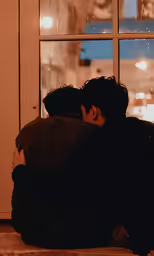 a young man with his arm wrapped around another man
