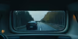 a car is on the highway in the reflection