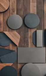 some circles and circulars sitting on top of a wooden floor