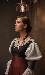 a woman wearing a traditional costume standing under a light fixture