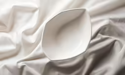 white plastic dish on a white fabric