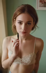 a young woman in a bra is holding a phone