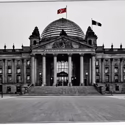 a very large building with some flags in front of it