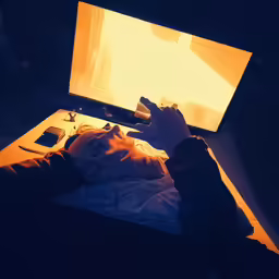 a person is using a laptop at night