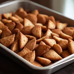 a pan full of pita chips on a table