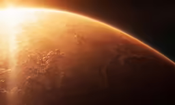 a bright orange glowing sun shines above a dark earth