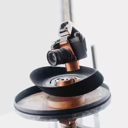 a tripod mounted on top of a cd