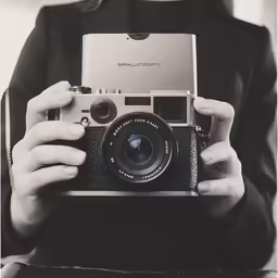 a person taking pictures with an old camera