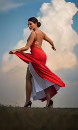 a woman with very long red dress standing on grass