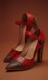 a red pair of heels with a leopard print on them