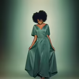 a woman standing with her hands in her pockets and holding the sides of her dress, which is flowing into the side