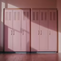 some pink lockers are lined up against a wall