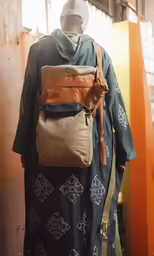 mannequin wearing a dress, hoodie, and bag with no hat