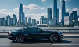 a dark colored sports car driving on a highway with a large city in the background