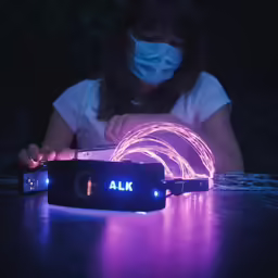 a woman wearing a face mask while looking at her phone