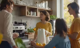 three women standing in a kitchen with lemons